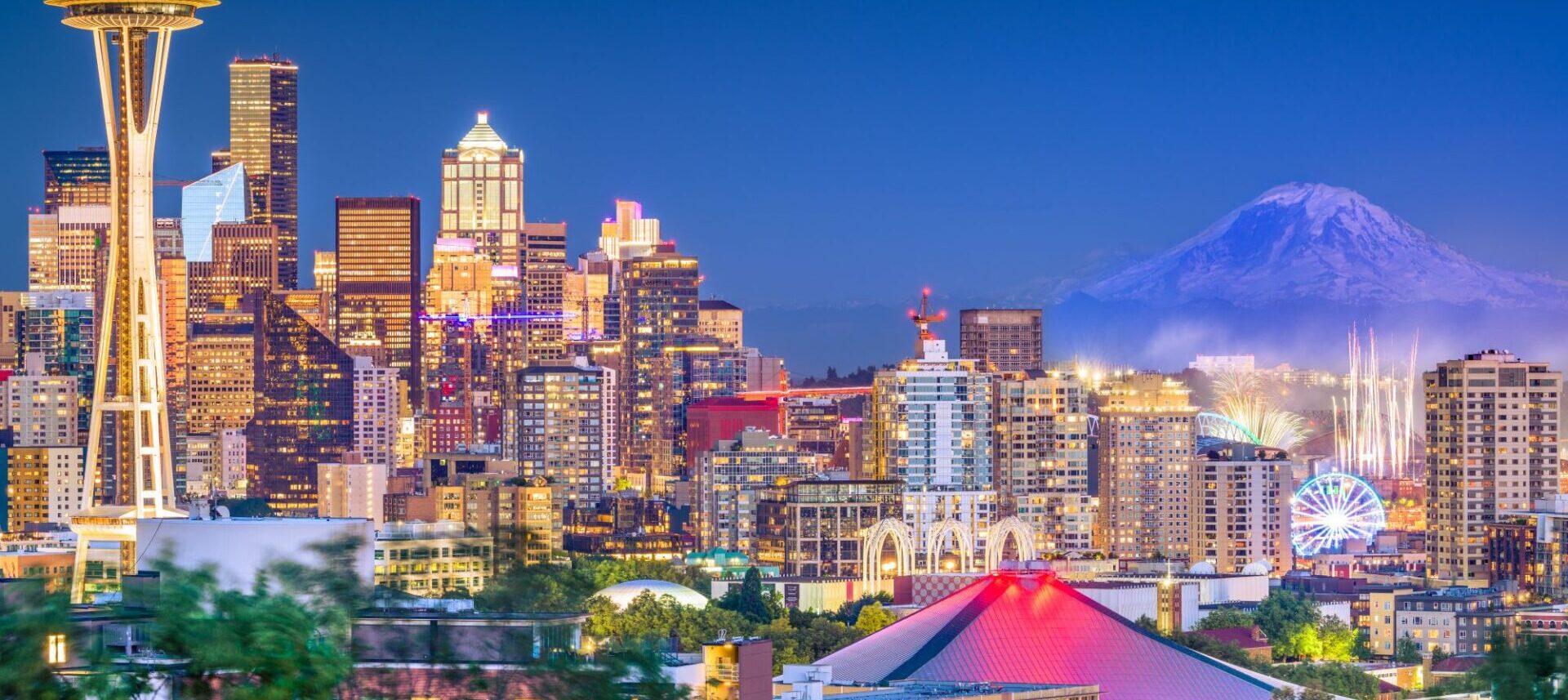 Seattle skyline at night with climate pledge arena and space needle